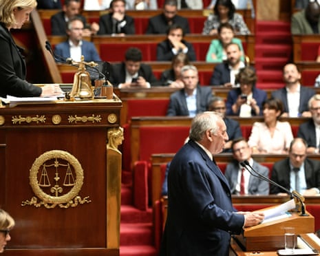 France's prime minister Francois Bayrou (R), next to President of the French National Assembly Yael Braun-Pivet (L, up), delivers his general policy statement during the parliamentary extraordinary session prior to a confidence vote over the government's austerity budget, at the National Assembly in Paris.