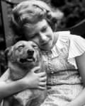 Princess Elizabeth hugging a corgi dog, 1936