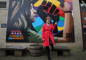 Glasgow, Scotland. First minister and leader of the Scottish National party, Nicola Sturgeon, beside a Black Lives Matters mural while campaigning for the Scottish parliamentary election