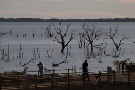 Tourists on the weir as the sunsets over Menindee Lake.