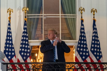 Donald Trump removes his protective mask on the Truman Balcony of the White House on 5 October 2020.