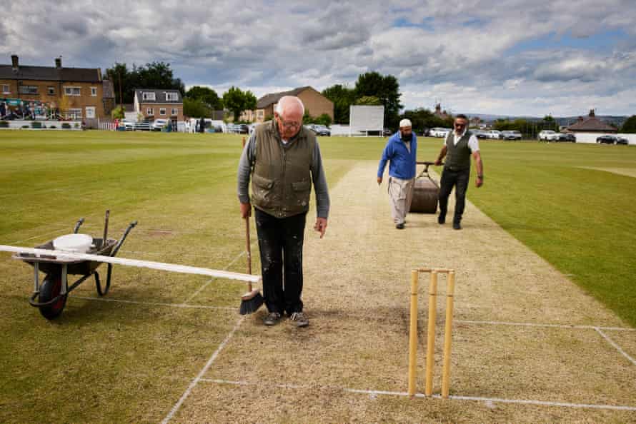 Yorkshire cricket’s great divide: ‘We’ve got to stop looking over the fence at each other’ | Cricket 5 Bowling Old Lane’s groundsman and club secretary Geoff Hanson (left) inspects his handiwork, with club chairman Nazaket Ali (right) and Jamil Ahmed manning the heavy roller.
