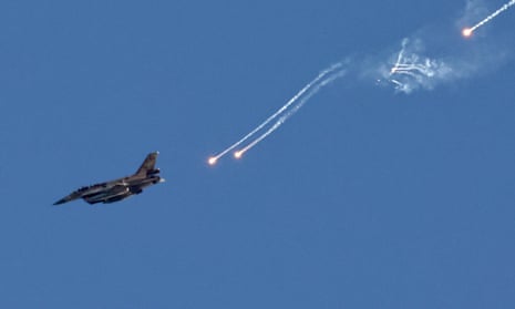 An Israeli fighter jet ejects flares over an area near the Lebanon-Israel border.