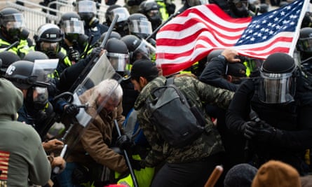 Supporters of US President Donald Trump fight with riot police outside the Capitol building on January 6, 2021