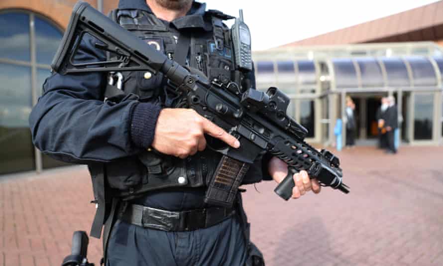 An armed police officer on patrol.