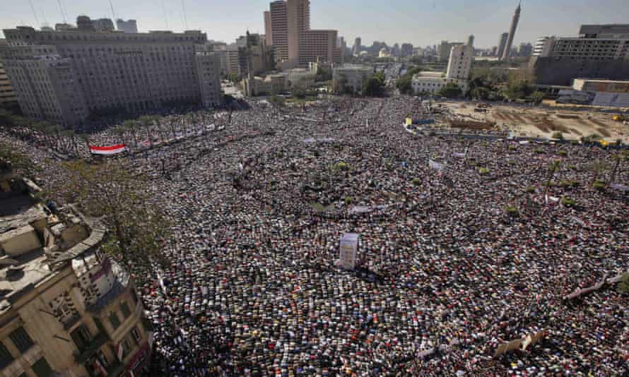 Egyptians in Tahrir Square, Cairo, pray and celebrate the fall of former President Hosni Mubarak's regime in February 2011.