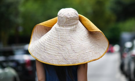 A woman in an oversized hat at Paris fashion week