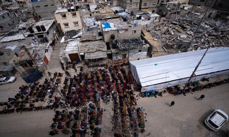 Palestinians perform Friday prayers of the Muslim holy month of Ramadan near the ruins of a destroyed mosque by the Israeli airstrikes in Rafah, Gaza Strip, Friday, March 22, 2024.