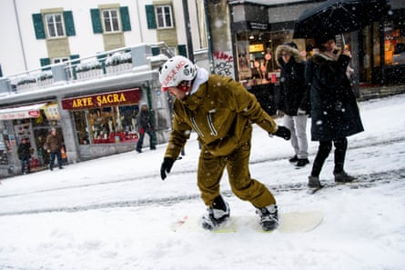 A snowboarder tries out a low-level technique in Lausanne, Switzerland