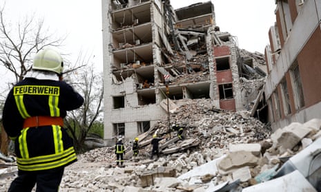 Rescuers work at the site of a destroyed building during a Russian missile strike.