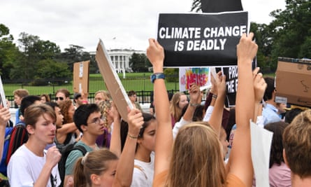 Youth activists take art in a climate protest outside the White House in Washington DC, on 13 September.