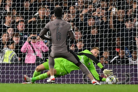 Fulham's Slovakian goalkeeper Marek Rodak saves the penalty by Tottenham Hotspur's Colombian defender Davinson Sanchez.