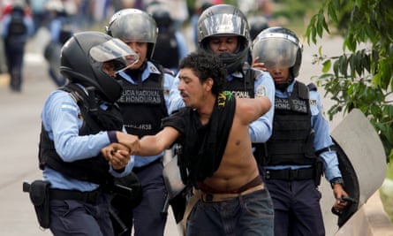 Policemen detain a demonstrator during a march against the government’s plans to privatize healthcare and education, in Tegucigalpa, Honduras, on Tuesday.