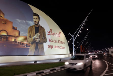 An advert for the Qatar One Pass featuring a heavily Photoshopped image of David Beckham at a busy road junction in Doha's Al Waab district.