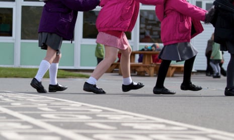 A line of schoolchildren play on a school playground