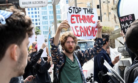 An Israeli protester holds up a sign reading: “stop the ethnic cleansing.” 