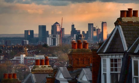 Typical Victorian homes and street with view across London to Canary Wharf