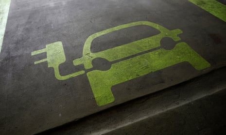 A sign is painted on a parking space for electric cars inside a car park in Hong Kong