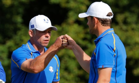 Team Europe’s Paul Casey and Bernd Wiesberger react on the 9th green after winning the hole.