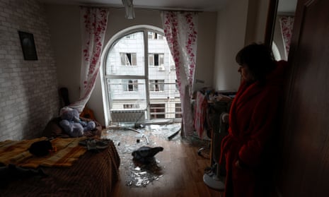Kateryna stands inside a room of her apartment damaged by a Russian drone strike in Kyiv, Ukraine.