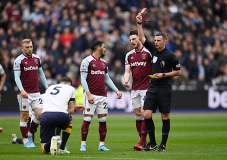 Michael Keane is shown a red card by referee Michael Oliver.