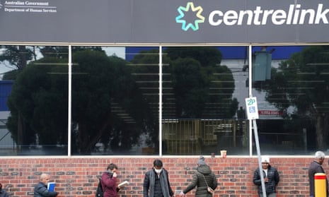 People queue outside a Centrelink office in Preston, Melbourne in March 2020. 