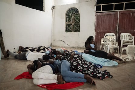 A community sleep together on the floor in the village church