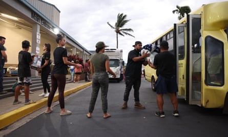 Volunteers with King’s Cathedral unload donations of blankets and supplies in Kahului, Maui