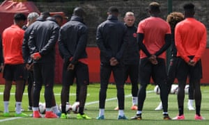 Manchester United’s English striker Wayne Rooney stands with teammates as they observe a minute’s silence for the victims of yesterday’s terror attack