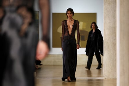 Deep focus shot of three models with painting behind