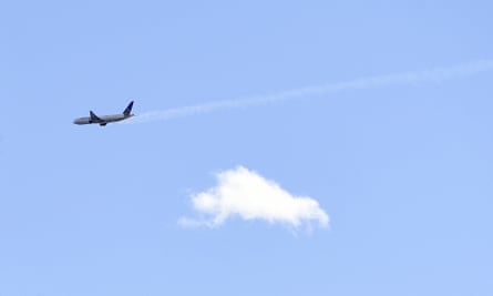 A United Airlines plane with smoke trailing from its right side is seen heading east towards Denver International Airport.