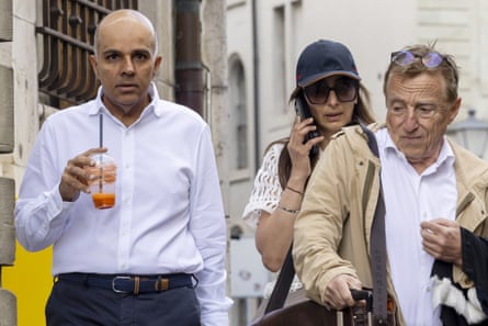 Ajay Hinduja and his wife, Namrata, with their lawyer Robert Assael outside court in Geneva in June.