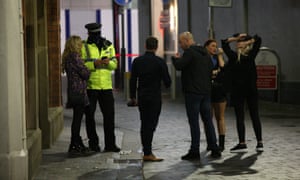 Police talk to people in Liverpool on the last weekend before stricter lockdown measures are expected across the north. Last weekend before pub closures, Liverpool, UK, 10 October 2020