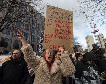 Demonstrators gather outside the Royal Mint Court in London to protest against plans to open the new Chinese embassy.