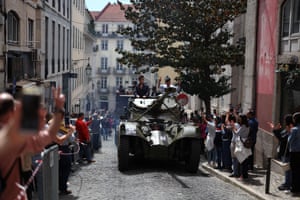 Retired members of the military parade through Lisbon in a tank