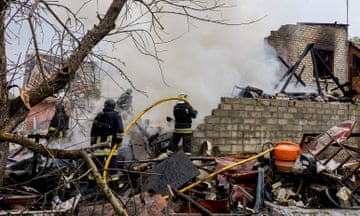 Ukrainian rescue workers at the site of a Russian strike in Derhachi, Kharkiv