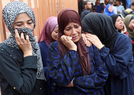 Mourners react during the funeral of Palestinians, who were killed by Israeli fire while trying to receive aid on Thursday, and who were killed in overnight Israeli airstrikes on tents, according to medics, at Nasser Hospital in Khan Younis, southern Gaza Strip, 1 August, 2025.