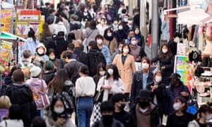 Pedestrians wearing protective face masks crowd a street at the Omotesando fashion district in Tokyo, Japan, on 30 November.