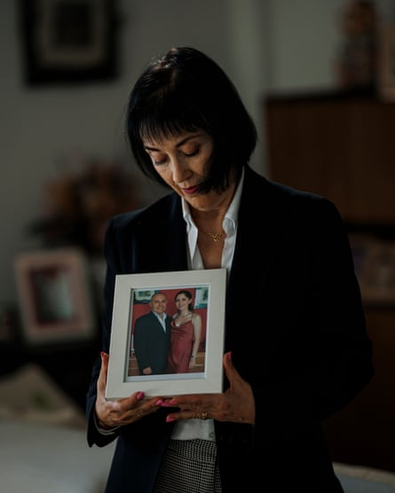 Toñi Garcia in her living room with a photo of her husband and daughter