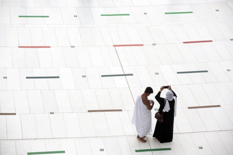 A couple take photos of the Kaaba before the Hajj pilgrimage takes places under special socially-distanced conditions.