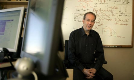 Andrew Conru posing in front of a whiteboard with calculations on it