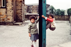 Two young children playing in the street in 1980s Bradford.