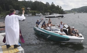 Pastor Daniel Toomey sends a spray of holy water for an annual blessing of boats in Harveys Lake, Pennsylvania, US