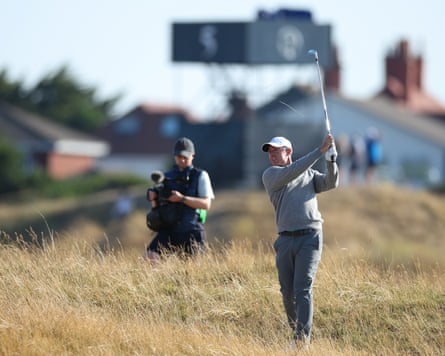 Rory McIlroy hits out of the parched rough as he limbers up to challenge for a second Open title