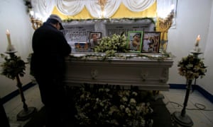A mourner stands by the coffin of a man killed in an anti-drug operation in Manila, philippines.