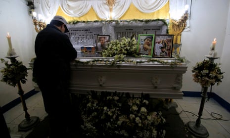 A mourner stands by the coffin of a man killed in an anti-drug operation in Manila, philippines.
