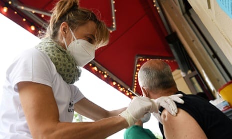 A medical assistant administers the Johnson &amp; Johnson vaccine at a bar in Berlin.