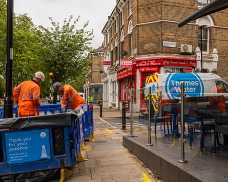 Thames Water employees mend a leak in a London street.