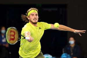 Tsitsipas hits a return against Nadal.
