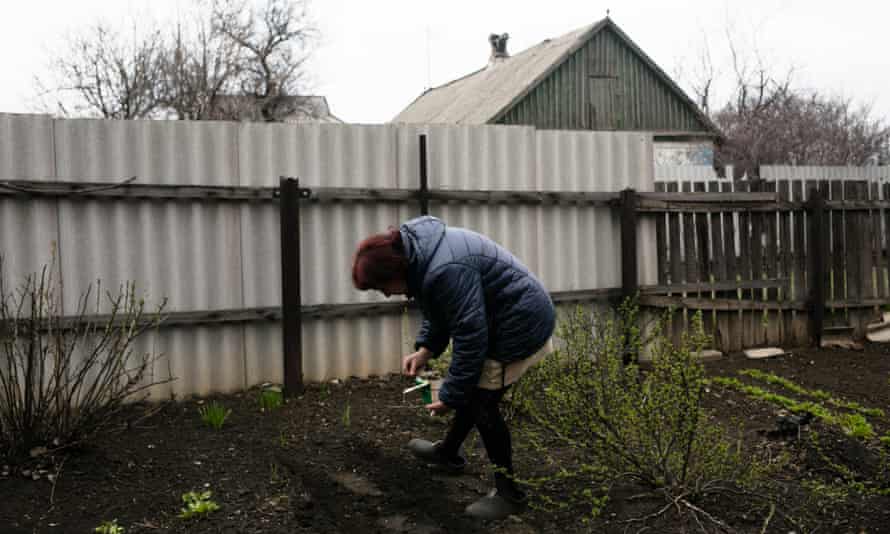 Svitlana Derkach takes care of her garden in Malinka.